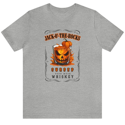 Grey Halloween Jack Whiskey Label Tshirt with Jack-o-the-Rocks title over a jack-o-lantern submerged in a lowball glass with filled with whiskey. The bottom of the label reads "Cursed Sour Mash Whiskey."