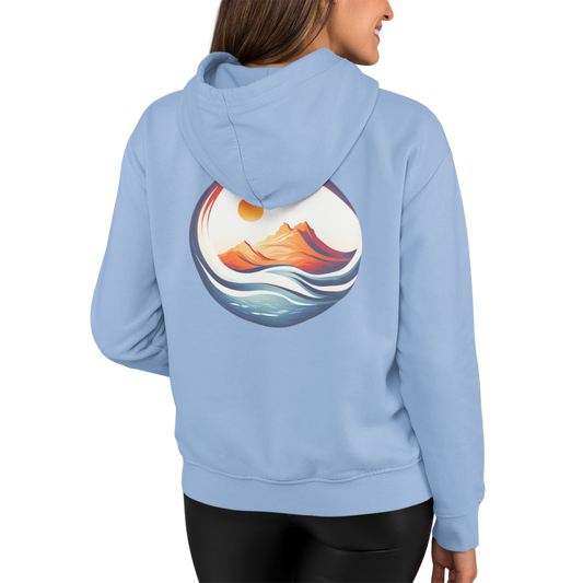 Woman wearing our light blue 'Be Free' Ocean Waves Hoodie showing a full back graphic of ocean waves around a mountain glowing in the sun.