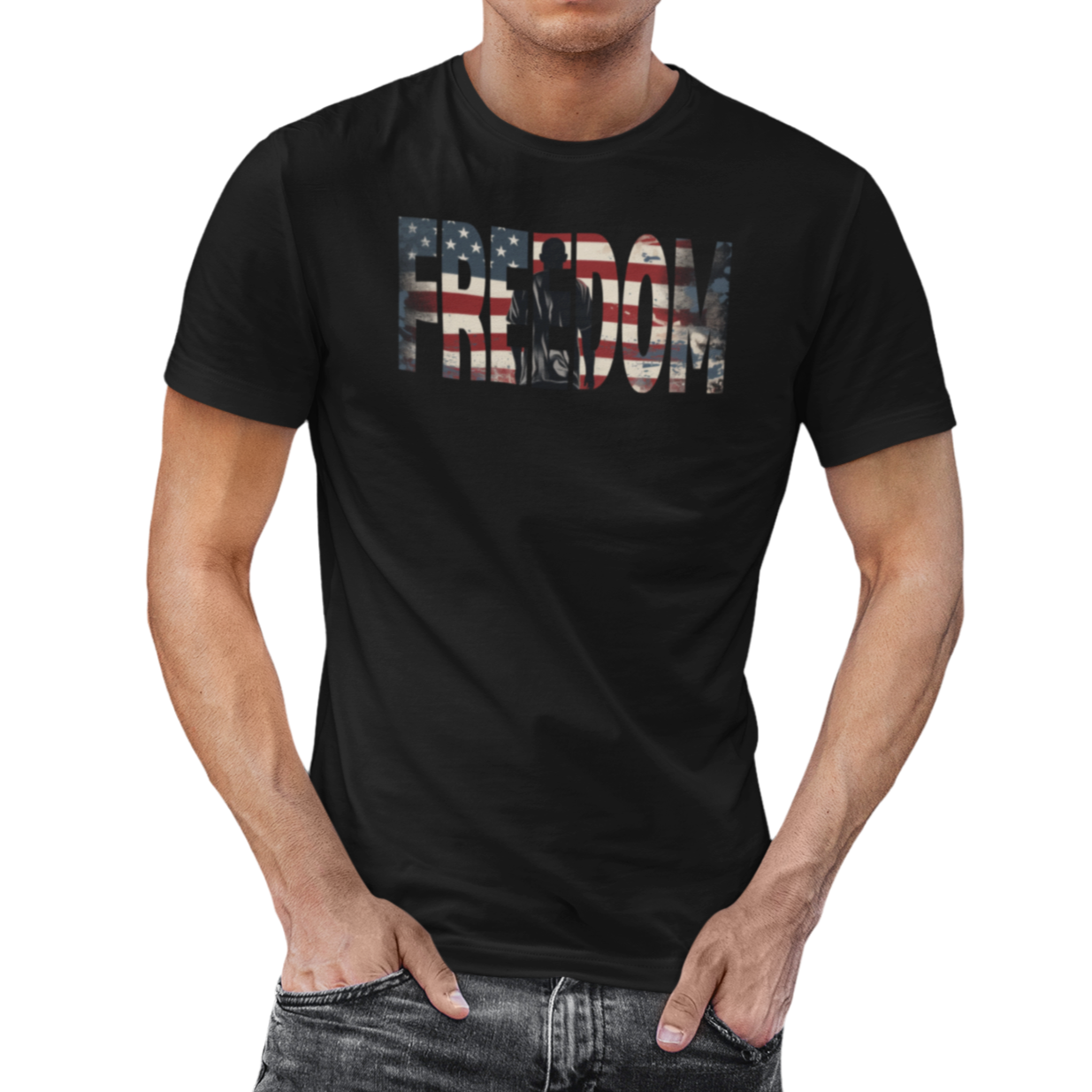 Man wearing our black Freedom USA Flag tee, which embodies the spirit of liberty and individualism. An American flag is outlined in the word 'Freedom' with a young man in silhouette gazing toward the stars and stripes, his back turned in reverence. 