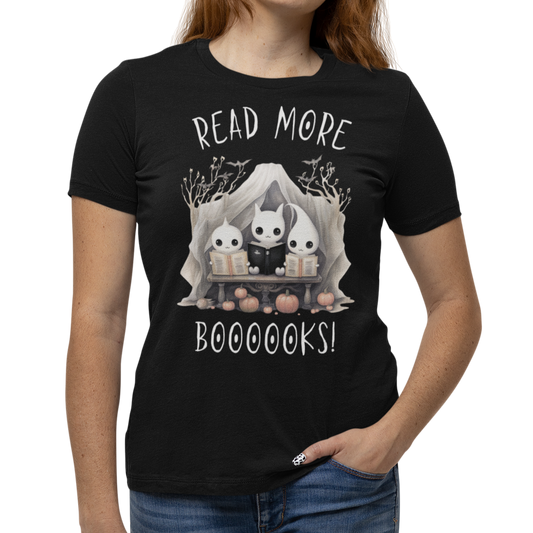 Woman wearing a black Halloween "Read More Boooooks!" tee with a trio of ghosts engrossed in books. Perfect for teachers, librarians, school staff, students, or anyone looking for classroom fun.